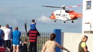 The Irish Coast Guard rescue helicopter airlifting the man to Limerick University Hospital after transfer from an ambulance crew inside Kilkee GAA Grounds on Sunday evening.