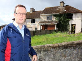 Cllr Joe Leddin outside derelict houses on Lenihan Avenue. Photo: Brendan Gleeson