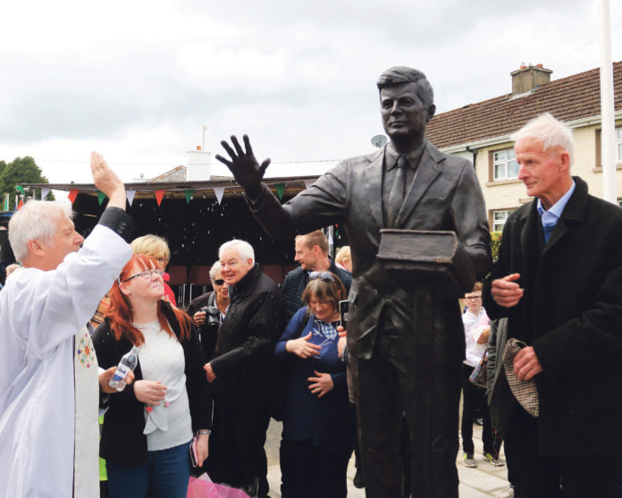 Fr Johnny Daly blessing the JFK statue in Bruff under the watchful eye of Michael Fitzgerald. Photo: Brendan Gleeson