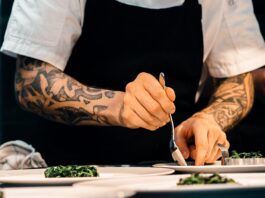 person putting food on plate