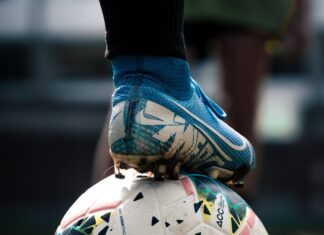 white and blue soccer ball on green grass field