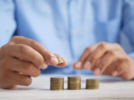 a person stacking coins on top of a table