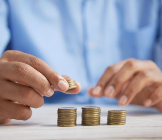 a person stacking coins on top of a table