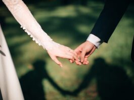 man and woman holding hands focus photo